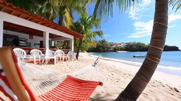 Tranquil beach scene featuring a hammock, palm trees, and a serene ocean view with distant houses photo