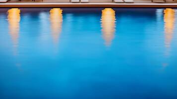 Tranquil evening at a pool with glowing lights reflecting on the serene water surface photo