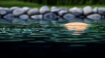 Tranquil pond reflecting a soft sunset, surrounded by smooth stones and lush greenery photo