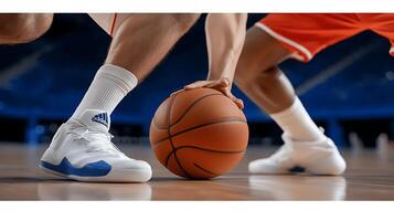 Two basketball players in dynamic action on court, focused on ball, with audience in background photo