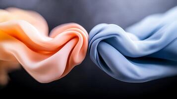 Two flowing fabrics intertwine gracefully, showcasing soft colors against a blurred backdrop photo