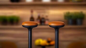 Two modern bar stools with orange seats in a cozy bar setting with blurred background items photo