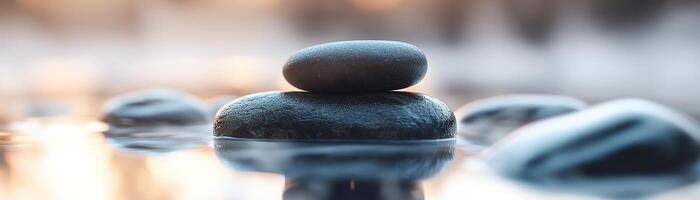 A series of smooth black stones gently balance over a misty water surface at dawn, evoking a sense of tranquility and focus. The stillness reflects a peaceful environment inviting contemplation photo
