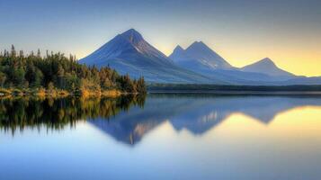 Mountains reflected in a lake at sunset photo