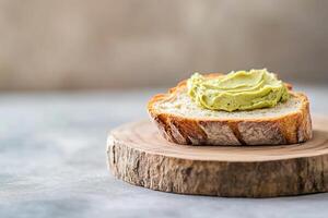 Warm, crusty bread is generously spread with pistachio butter, showcasing a delightful contrast of textures. This rustic presentation captures the essence of simple, comforting food photo