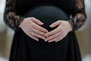 Partners embrace the bond of impending parenthood, gently holding a pregnant belly. The soft blur around them enhances the feeling of love and support in their intimate moment photo