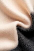 A soft-focus wool surface transitions from a light beige to rich black, creating a striking gradient. This contemporary textile embodies a sophisticated fashion style photo
