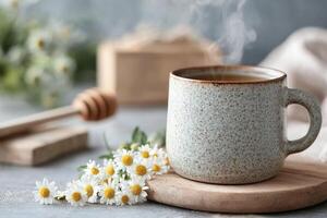 A steaming cup of herbal tea rests in a rustic ceramic mug, surrounded by fresh chamomile flowers and a wooden honey dipper, creating a peaceful atmosphere perfect for relaxation photo