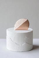 A stunning minimalist cake features sharp, angular fondant textures and is adorned with metallic geometric shapes, ideal for contemporary celebratory events or branding purposes photo