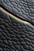 Rich black leather showcases intricate embossed patterns and subtle gold foil accents, creating an elegant surface ideal for premium text placement and upscale design elements photo