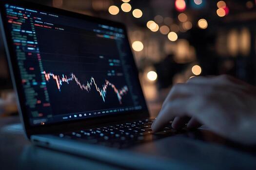 A trader analyzes glowing market trends on a sleek laptop, immersed in investment decisions while a blurred ambiance surrounds them. The setting reveals a dynamic trading environment photo