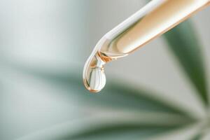 Close-up capture of a golden CBD oil dropper releasing a droplet onto a fresh green hemp leaf against a softly blurred background, evoking feelings of purity and healing photo