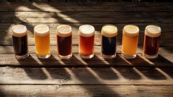 Six different types of beer are lined up on a wooden table photo