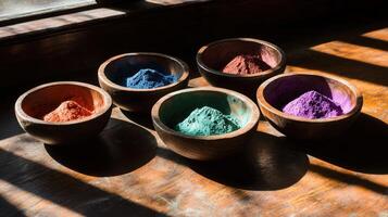 Colorful powders in bowls on a wooden table photo