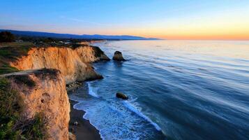 A large cliff with a beach and ocean in the background photo