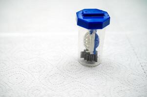 close-up of a container for cleaning and storing contact lenses for eyes, used at home. For soft and hard lenses. photo