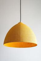 Bright yellow linen pendant lamp with arched shape, perfect for modern interiors. This stylish lighting fixture adds warm glow to any space, enhancing ambiance beautifully photo