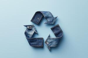 Recycle symbol made from jeans on blue background photo