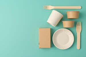 Paper plates, forks and spoons on a blue background photo