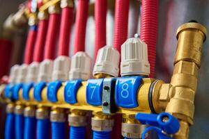 Underfloor heating manifold with valves and flow meters, close up photo