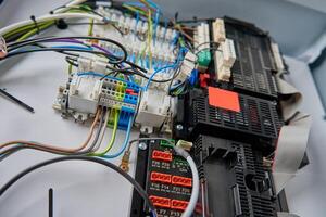 Close-up view of wiring system and circuit board inside electrical control panel photo