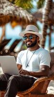 Man Working on Laptop at Beach Vacation Spot photo