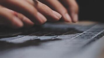 A person typing on a laptop keyboard video