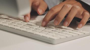 A person typing on a computer keyboard video