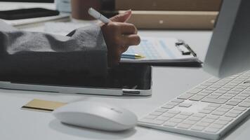 A person is writing on a piece of paper while sitting at a desk video