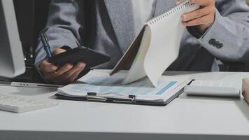 A person in a suit holding a notepad and a pen video