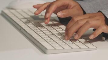 A person typing on a keyboard video