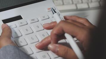 A person is using a calculator to calculate a number video