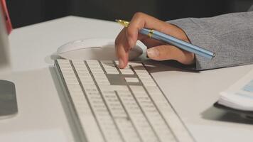 A person is typing on a keyboard with a pen video