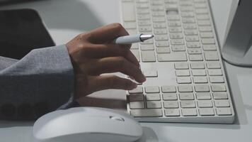 A person is typing on a keyboard with a pen video