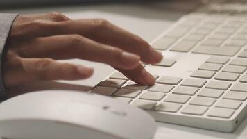 A person is typing on a computer keyboard video