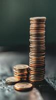 A stack of coins sitting on top of a table photo