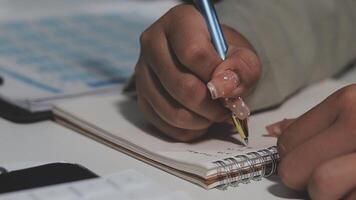 A person is writing on a notebook with a pen video
