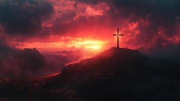 christian cross standing on mountain peak at sunset with dramatic sky photo