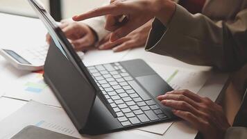A person is pointing at a laptop computer video