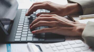 A person typing on a laptop computer video