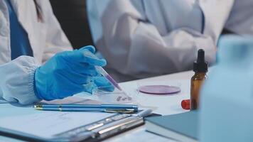 A person in a lab coat is holding a test tube video