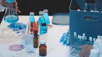 Two people in lab coats are working on a project video