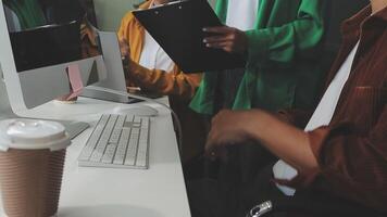 A man and woman are working on a computer video