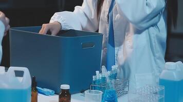 A woman in a lab coat is holding a container video