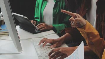 People working on a computer with one pointing at something video
