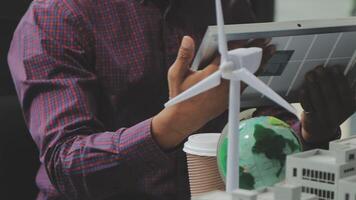Man using tablet with wind turbines video