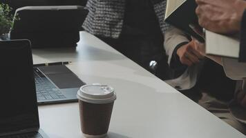 A laptop computer on a table with a cup of coffee video