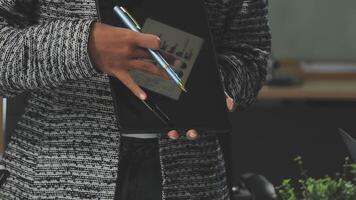 A person holding a pen and tablet in front of them video