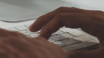 A person typing on a keyboard video