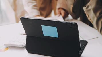 A person is using a tablet computer with a blue sticker video